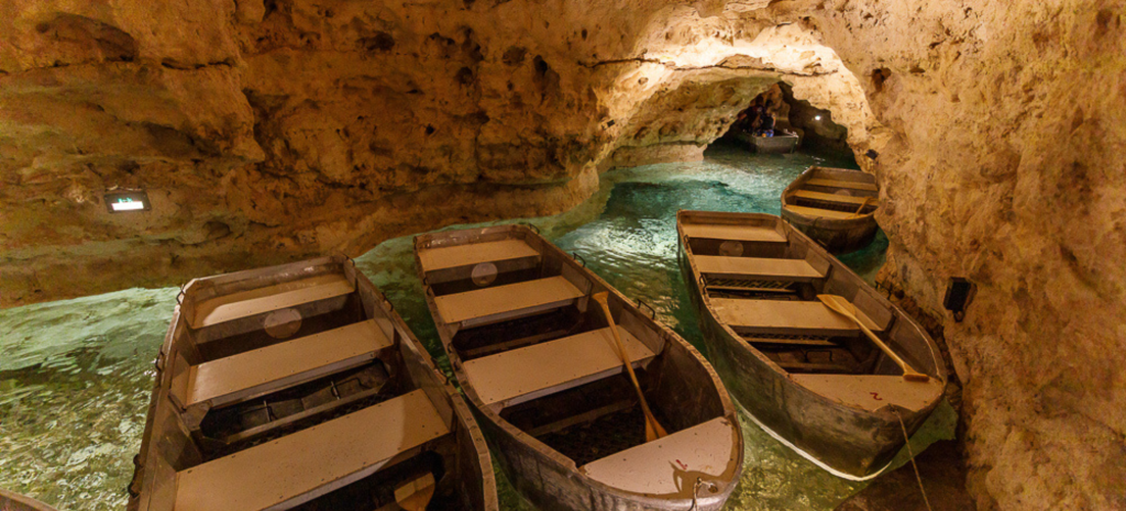 Rowboats on the crystal-clear waters of Tapolca Lake Cave in Hungary