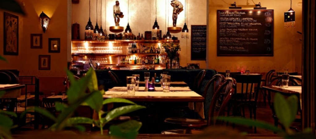 Warm, intimate interior of Két Szerecsen Bistro in Budapest with dim lights and cozy atmosphere.