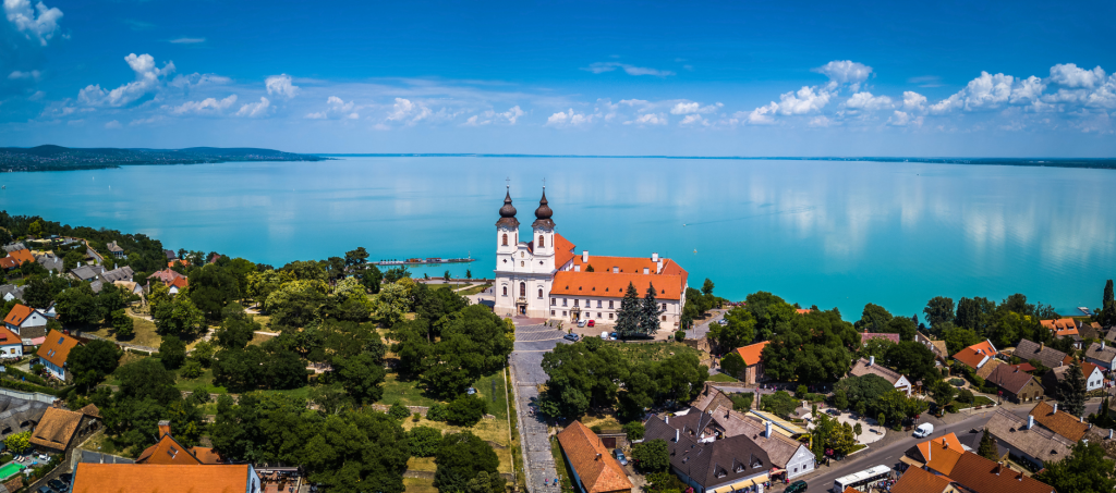 Aerial view of the Tihany Benedictine Abbey overlooking Lake Balaton with a stunning panoramic backdrop.