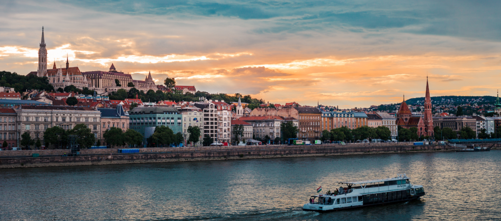 Danube River sunset cruise in Budapest with illuminated skyline and bridges