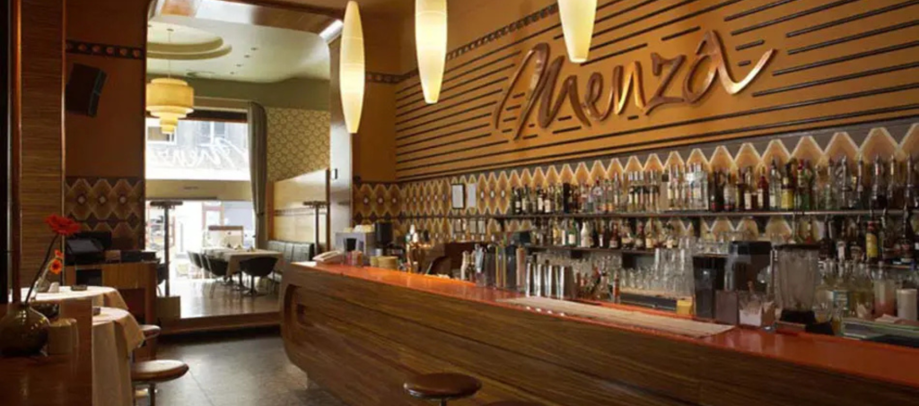 Interior of Menza restaurant in Budapest with retro design and bar counter.