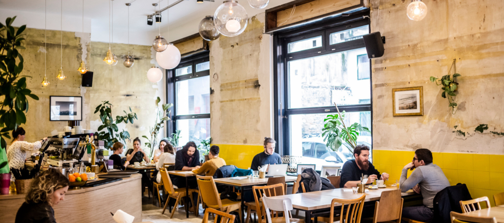 Inside Dobrumba restaurant in Budapest with Mediterranean atmosphere and lively guests.