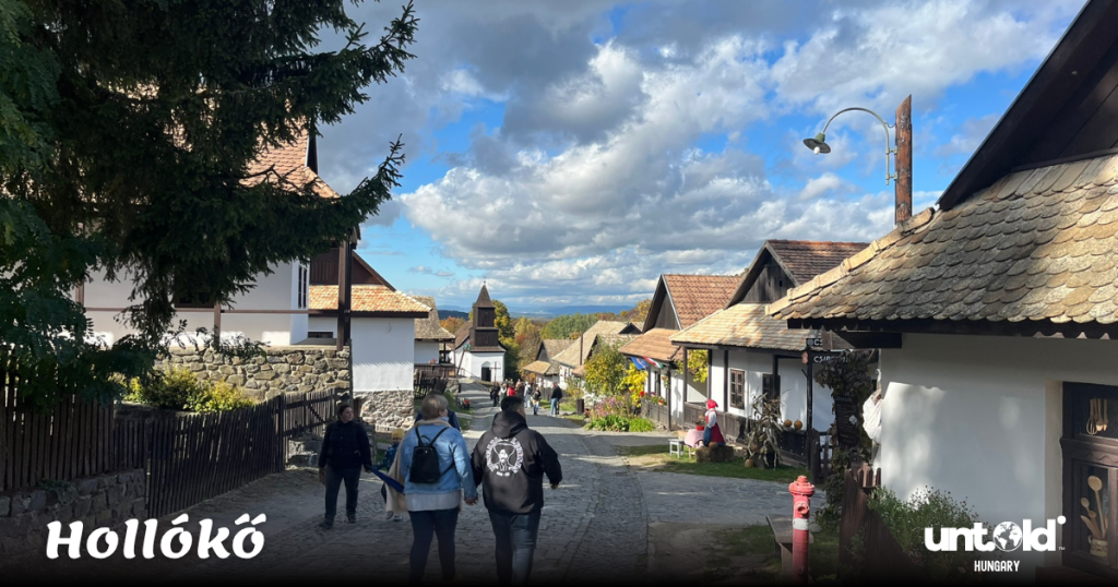 Picturesque view over Hollókő’s traditional houses and surrounding autumn hills seen from a high vantage point.