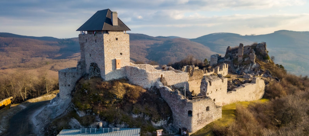 Aerial view of Regéc Castle surrounded by forested hills, one of Hungary’s most remote and atmospheric fortresses.